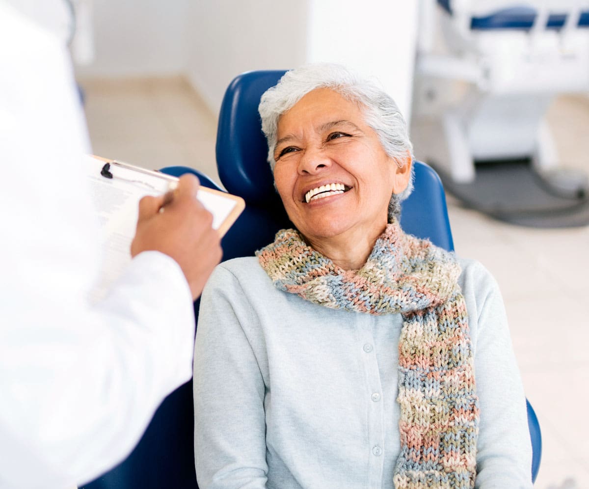 Smiling Woman In Chair At Dentist